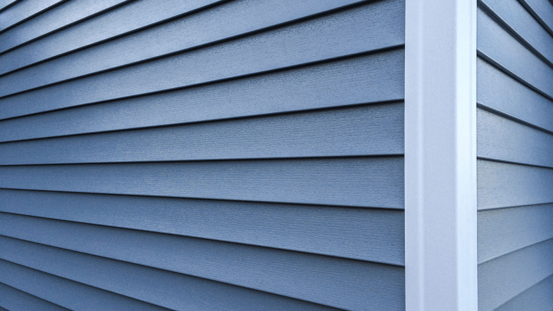 Vinyl siding panels on a residential home showing typical overlap seams