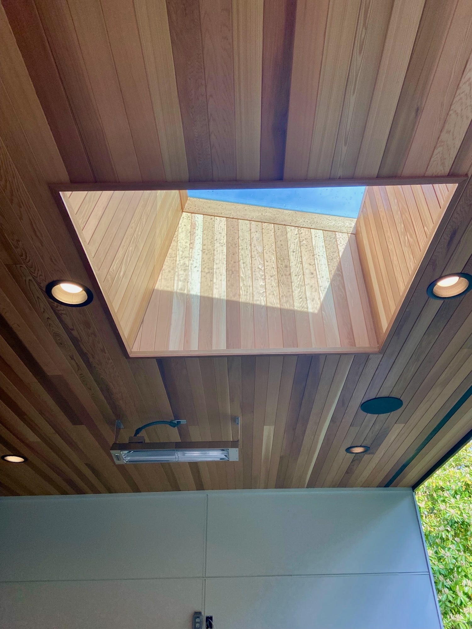 Western Red Cedar soffit ceiling framed around a skylight opening on a covered exterior